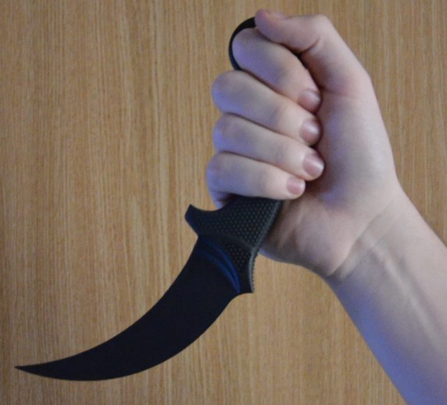 hand holding karambit knife