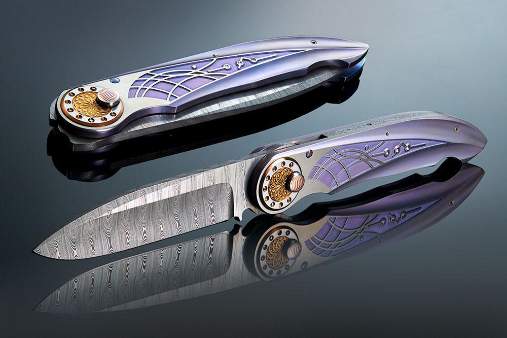 Michael Walker Folding Knives Two Michael Walker titanium folding knives with Damascus blades and purple anodized handle inlays